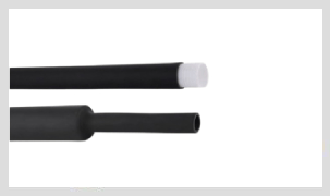 Two lengths of matt black tubing on a white ground. The upper length is held open by a white inner core protruding from its cut end; the lower length is empty, showing an open bore.